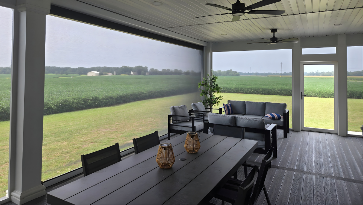 Motorized outdoor shade screen installed on a covered porch in Galena Maryland, reducing glare while maintaining open countryside views across the Eastern Shore farmland.