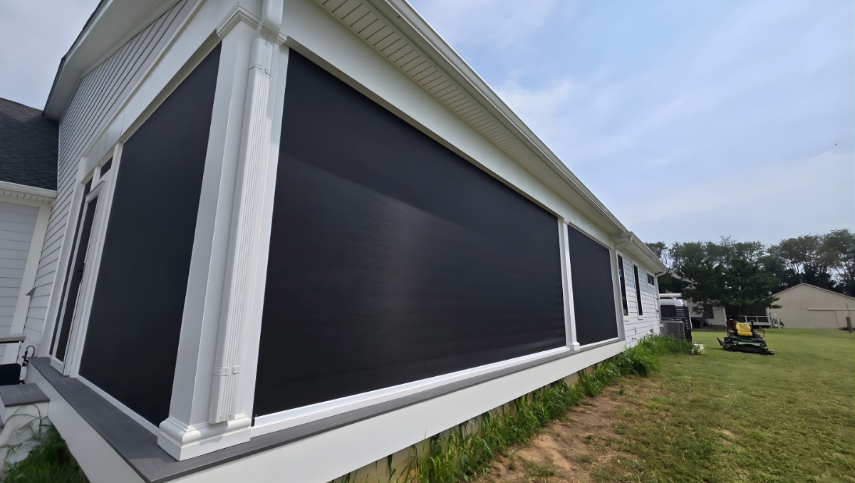 Exterior motorized solar shade screens installed on a residential porch in Galena Maryland providing sun protection, privacy, and cooling for outdoor living spaces.