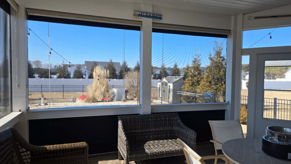 clear vinyl porch enclosure protecting outdoor furniture from wind and debris