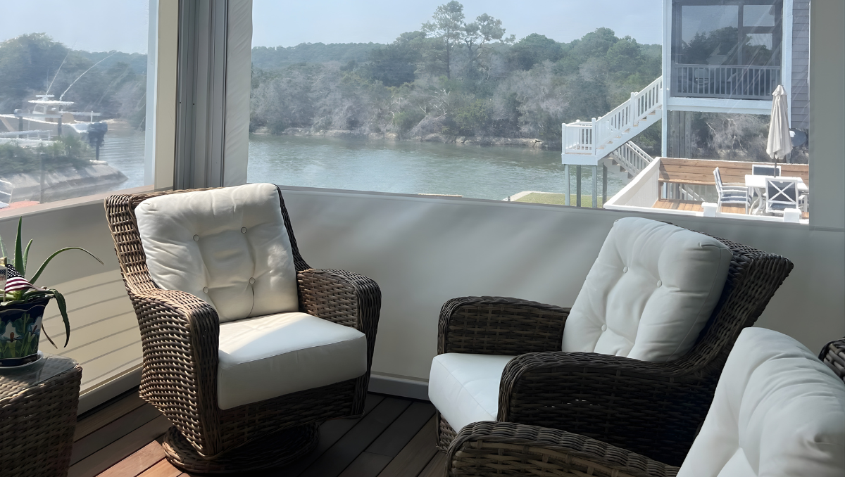looking out from enclosed porch with clear vinyl panels toward waterfront view on Eastern Shore
