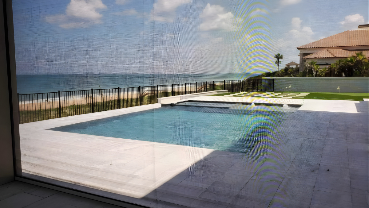 view through shade screen overlooking pool and waterfront area