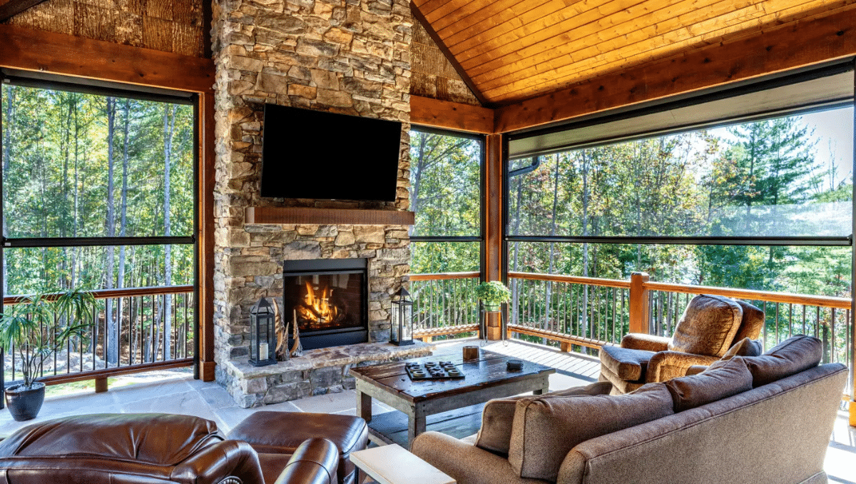 Covered porch with fireplace and outdoor patio screens for year-round outdoor comfort