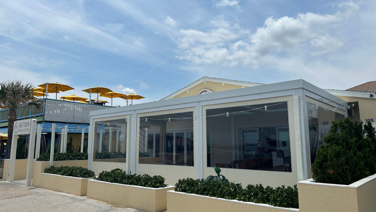 Restaurant outdoor dining area enclosed with commercial vinyl patio panels for weather protection