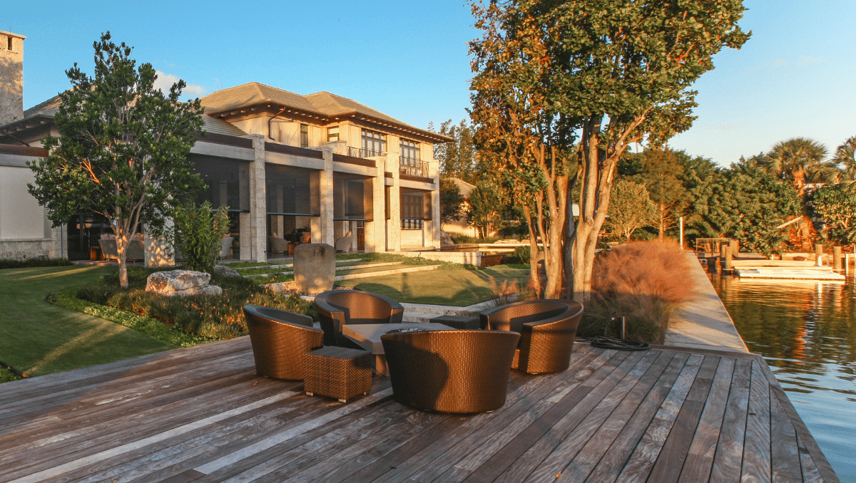 Waterfront home with outdoor patio screens helping protect outdoor living spaces near the water