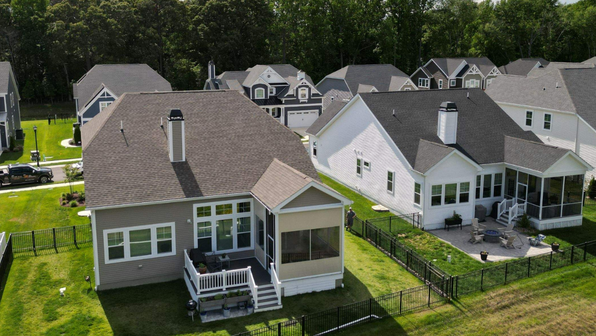 Motorized Vinyl Porch Enclosure with Crystal-Clear Views in Lewes, Delaware Aerial view of a Delaware home featuring a motorized vinyl porch enclosure with clear viewing panels, providing protection from wind, rain, bugs, and pollen while preserving backyard views