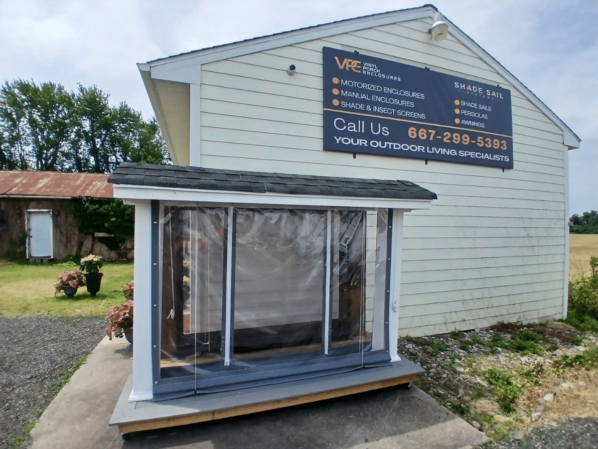 Outdoor Living Showroom Maryland exterior featuring a custom vinyl porch enclosure display outside our Denton showroom.