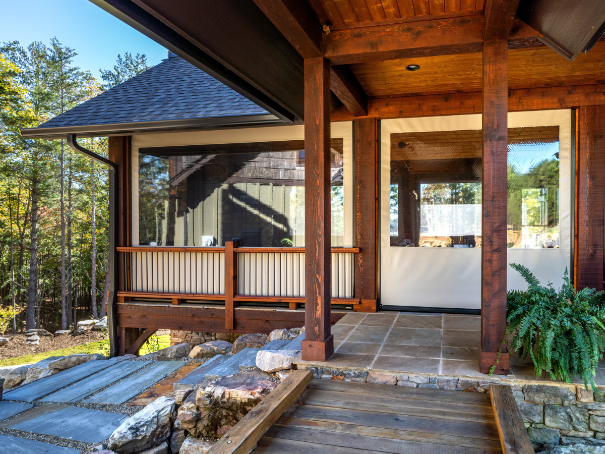Exterior of a luxury covered porch fitted with custom clear vinyl enclosure panels.