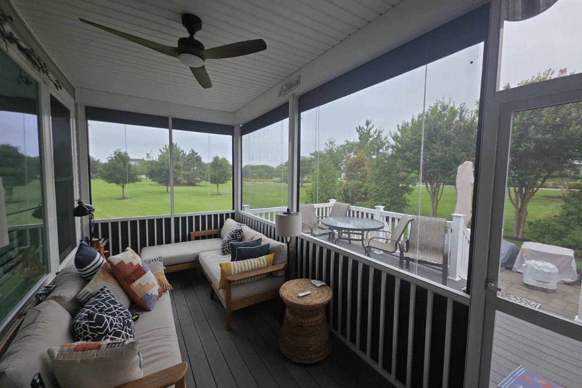 Vinyl porch enclosures protecting a screened porch while maintaining clear outdoor views