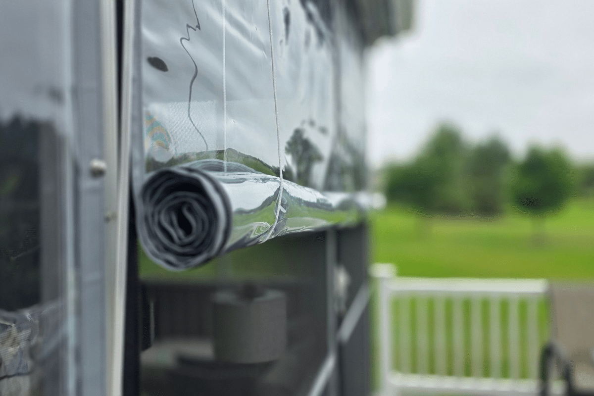 Close-up of a clear vinyl porch panel rolled up